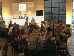 The Dallas Stars' table and local play-by-play men watch Dave Strader at the Talk of the Town event