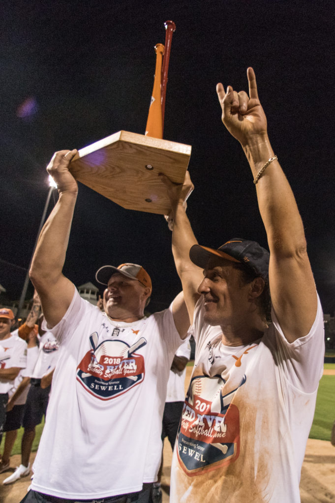 Roger Clemens and Matthew McConaughey hoist the Red River softball trophy